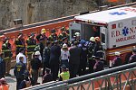 In a solemn, worldless ceremony marking wight months of cleanup from the terrorist attacks of September 11, 2001, which destroyed the twin towers of the World Trade Center, an empty stretcher is carried up the ramp from the pit, and the last steel column is carried out on a truck. An honor guard of police, firefighters, contruction workers, rescue personnel, and military lined the ramp. Families of victims were present as was Mayor Michael Bloomberg.