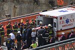 In a solemn, worldless ceremony marking eight months of cleanup from the terrorist attacks of September 11, 2001, which destroyed the twin towers of the World Trade Center, an empty stretcher is carried up the ramp from the pit, and the last steel column is carried out on a truck. An honor guard of police, firefighters, contruction workers, rescue personnel, and military lined the ramp. Families of victims were present as was Mayor Michael Bloomberg.