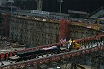 In a solemn, wordless ceremony marking the end of eight monyhs of cleanup from the terrorist attacks of September 11, 2001 which destroyed the twin towers of the World Trade Center, an empty stretcher is carried up the ramp from the pit, and the last steel column is carried out on a truck. An honor guard of police, firefighters, construction workers, and rescue personnel lined the ramp. Familes of victims were present as was Mayor Michael Bloomberg.