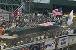 In a solemn, wordless ceremony marking the end of eight monyhs of cleanup from the terrorist attacks of September 11, 2001 which destroyed the twin towers of the World Trade Center, an empty stretcher is carried up the ramp from the pit, and the last steel column is carried out on a truck. An honor guard of police, firefighters, construction workers, and rescue personnel lined the ramp. Familes of victims were present as was Mayor Michael Bloomberg.