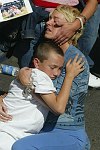 Families of the victims of the terror attacks on the World Trade Center in New York City which killed almost 3,000 people on 11 September 2001 commemorate the 1st anniversary of the tragedy on 11 September 2002.<br>A grieving Kathy Trant, embracing son Alex, listens for the name of husband Daniel during a recitation of the dead.