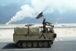 U.S. Troops on a mechanized march from Kuwait into Iraq with M1A1 Abrams tanks, M3 Bradley Fighting Vehicles, APCs, and other vehicles leave the burning oil fields into the Wadi Al-Bateen.