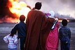 Family of oil worker looking at burning oil wells a few hundred meters from their home. Al Ahmadi, Kuwait