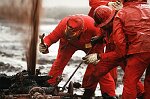 U.S. Oil Well firefighters from Boots and Coots of Texas extinguish their first oil well fire in Al Ahmadi, Kuwait