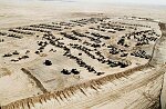 British troops guard captured Iraqi armor and weapons in the Kuwaiti desert.
