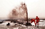 U.S. Oil Well firefighters from Boots and Coots of Texas extinguish their first oil well fire in Al Ahmadi, Kuwait