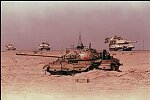 US M1A1s on the road in Iraq pass a destroyed Iraqi tank after the liberation of Kuwait, Operation Desert Storm, 1991