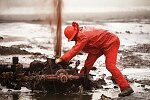 U.S. Oil Well firefighters from Boots and Coots of Texas extinguish their first oil well fire in Al Ahmadi, Kuwait