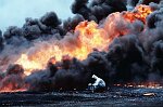 Al Ahmadi oilfields where wells set on fire by retreating Iraqi troops burn out of control. Michael Bailey takes samples for environmental testing. The skies are black wit soot.