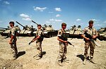British troops guard captured Iraqi armor and weapons in the Kuwaiti desert.