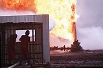 U.S. Oil Well firefighters from Boots and Coots of Texas extinguish their first oil well fire in Al Ahmadi, Kuwait