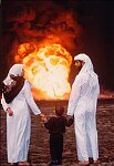 A Kuwaiti family surveys the oil fields set ablaze by Saddam Hussein after his defeat in the Gulfl War. Al-Ahmadi, Kuwait, 1991