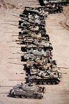 British troops guard captured Iraqi armor and weapons in the Kuwaiti desert.