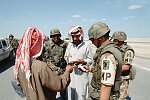 U.S. troops check I.D.'s of Arabs on the cease-fire line inside Iraq.