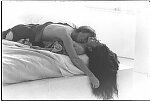 John Lennon and Yoko Ono during the filming of a video to promote their new album, Double Fantasy, New York City, November 26, 1980. Filming began in Central Park, then moved to a gallery on SoHo for scenes where they would arrive in a white bedroom, first in street clothes and later in kimonos, strip, and make love.