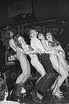 The Tubes' Fee Waybill in a girl sandwich at the Bottom Line, NYC, 11/75<br>0834-13<br>From SoHo Blues - A Personal Photographic Diary of New York City in the 1970s by SoHo Weekly News chief photographer Allan Tannenbaum