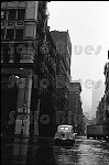 An old car crosses Broome St. at Mercer St., SoHo 12/31/73<br>0020-08<br>From SoHo Blues - A Personal Photographic Diary of New York City in the 1970s by SoHo Weekly News chief photographer Allan Tannenbaum