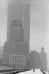 A cross-country skiier passes the World Trade Center on the disused West Side Highway during a snowstorm.<br>SN 1952-5