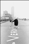 An artist named Veronica paints her name on the disused West Side Highway in Tribeca. The World Trade Center looms in the background.<br>SN 2158-12
