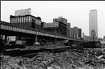 The ntwin towers of the World Trade Center loom over undeveloped Tribeca, with the almost finished Independence Plaza in the center. 3/1974<br>SN 0098-15<br>SWN