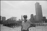 Alice Aycock and her Sculpture on the Battery Park City Landfill, also known as Tribeca Beach. The World Trade Center twin towers loom in the background.<br>SN 3151-5